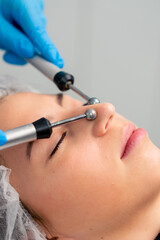 close-up of a beautician doctor massaging the skin of a client's face during a beauty and health cosmetic procedure