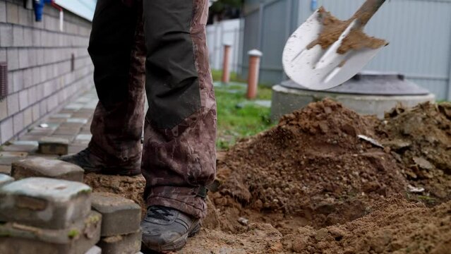 workers digging trench for gas supply system for house in cottage village, repair and installation works, details