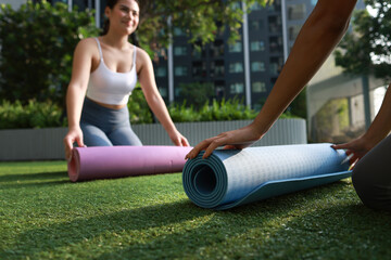 A couple young woman with sport uniform prepare yoga mats at the poolside, Yoga exercise