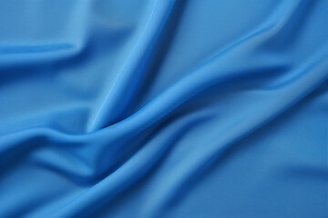 background of the texture of a blue smooth textile fabric laid in soft folds close-up,wallpaper concept,the basis for the banner