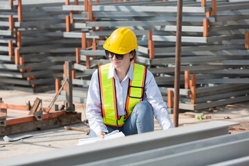 Foreman builder woman at construction site. Female engineer inspecting work at construction site,...