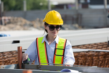 Foreman builder woman at construction site. Female engineer inspecting work at construction site,...