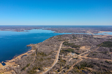 Fototapeta na wymiar Expansive aerial views over Tay Township, Simcoe County, Ontario, capture the grandeur of the Canadian landscape. From the shimmering waters reflecting the sun's glare to the sprawling patches.