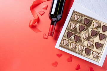 valentine sweet chocolate and red wine on red background