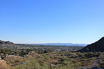 Fototapeta na wymiar Arizona Capital City of Phoenix downtown under cloudless sky as seen from North Mountain Park toward South mountains