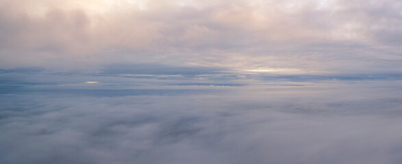 Fototapeta na wymiar Aerial Dreamscape: Wings Over a Sea of Puffy Clouds