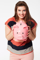 Fototapeta na wymiar Finance, portrait and woman with piggy bank in studio for savings, payment our budget on white background. Money, box or face of person with cash container for investment or future financial freedom
