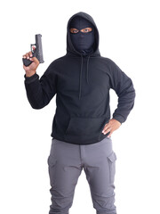 Unidentified male criminal wearing a black hoodie and covering his face, holding a pistol and...