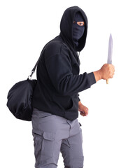 An unidentified male criminal wearing a black hoodie and covering his face, holding a sharp knife and carrying a large black money bag. On a white background with a clipping path.