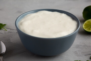 Homemade Mexican Crema Sauce in a Bowl, side view.