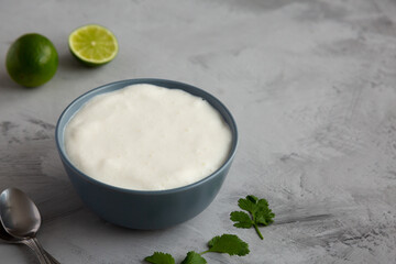 Homemade Mexican Crema Sauce in a Bowl, side view. Copy space.