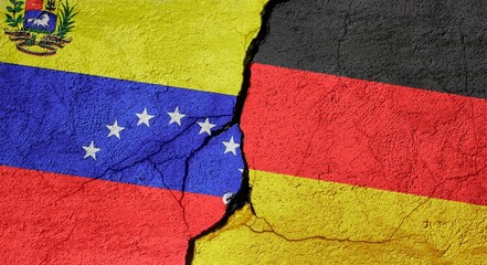 Venezuela and Germany flags on a stone wall with a crack, illustration of the concept of a global crisis in political and economic relations