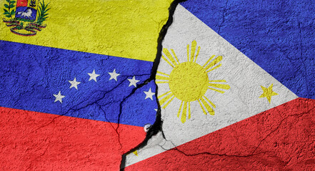 Venezuela and Philippines flags on a stone wall with a crack, illustration of the concept of a global crisis in political and economic relations