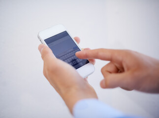 Hands, phone and typing on screen for communication or text message in studio, texting and conversation. Smartphone, person and replying or speaking online, contact and discussion by white background