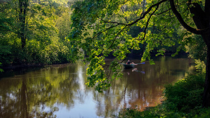 Water landscape with boat on sunny spring day.