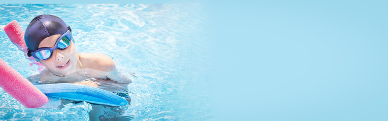 Banner of active child (boy) in cap, sport goggles having fun in swimming pool. Kid enjoying water....