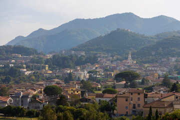 Fototapeta na wymiar Campania region panoramic Irno valley in the province of Salerno, landscape of a small village with bell tower in the center under the hills