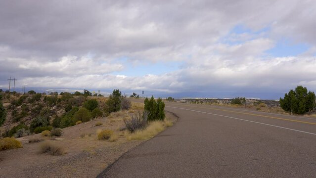Establishing shot of brown mountains with green forest in The Hogback Scenic Root 12, Utah, North America. Day time on October 2023. ProRes 422 HQ.