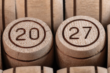 The number 2027 on a small wooden barrel