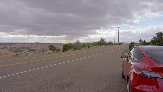 Establishing shot of brown mountains with green forest in The Hogback Scenic Root 12, Utah, North America. Day time on October 2023. ProRes 422 HQ.