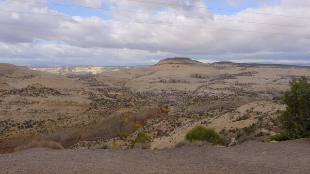 Establishing shot of brown mountains with green forest in The Hogback Scenic Root 12, Utah, North America. Day time on October 2023. ProRes 422 HQ.