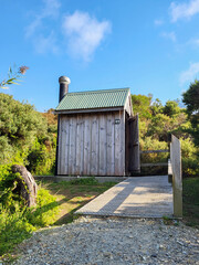 Unisex wooden toilet in bushland. Traditional dunny for hikers in the outback Wilson's Promontory National Park.