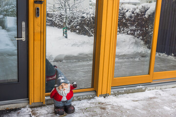 Beautiful Christmas view of a welcoming gnome standing near the entrance door of the villa on a...