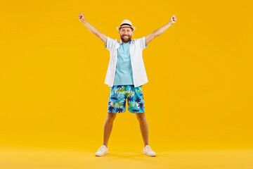 Full body photo of young happy man standing with hands up in fists wearing summer casual clothes...