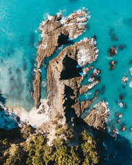 Vertical drone photo above ohope beach in New Zealand showing beaches, different rock formations,...