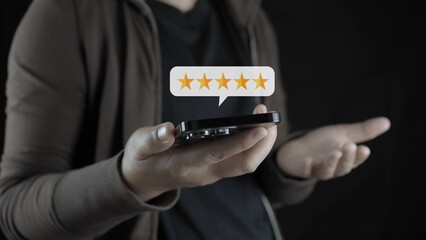 customer man hand pressing on smartphone screen with gold five star rating feedback icon and press...