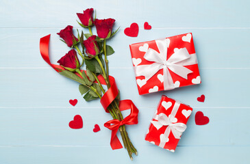 Red rose flowers with gift box on wooden background, top, view. Valentine's day concept
