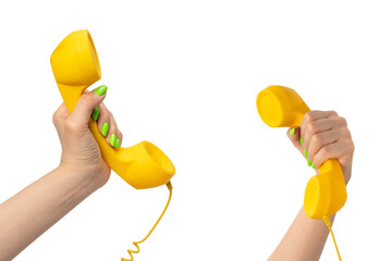 Yellow handset in woman hand with green nails isolated on a white background.