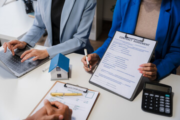 Real estate agent and customer signing contract to buy house, insurance or loan real estate.rent a house,get insurance or loan real estate or property.