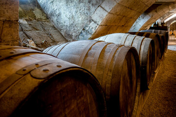Barrels in a rustic wine cellar