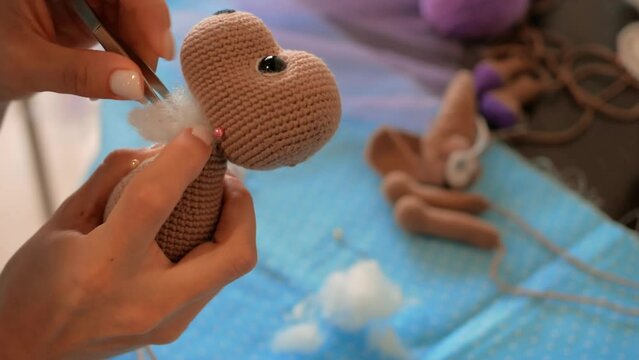 Stuffing toy, meticulous craft handiwork. art toy-making, detailed process of stuffing. skill precision handcrafting, dedication craftsmanship creation hand-stuffed toys, appeal traditional handiwork.