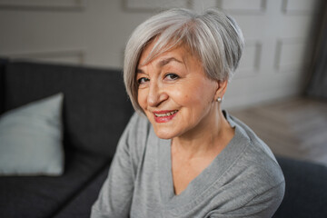 Fototapeta na wymiar Portrait of confident stylish european middle aged senior woman. Older mature 60s lady smiling at home. Happy attractive senior female looking camera close up face headshot portrait. Happy people