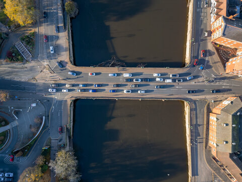 Looking straight down at traffic crossing the Worcester Bridge in Worcestershire, UK