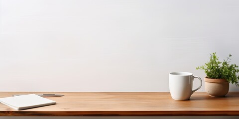 Front view of a workspace with a white desk table, copy space, supplies, and a coffee mug.