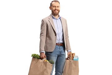 Smiling young man carrying grocery bags