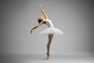 Full length shot of a ballerina dancing and leaning backwards - obrazy, fototapety, plakaty