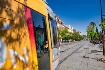 Sevilla, Spain - April 10, 2023:City tram along central street on a sunny day