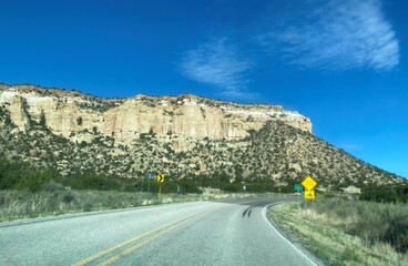A road curving around a rock
