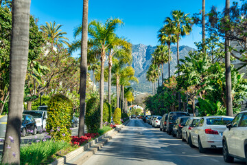 Marbella, Spain - April 7, 2023: A long boulevard near the ocean on a sunny spring day