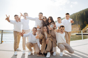 friendship, movement, action, freedom and people concepts - group of happy teenage students or school friends posing and having fun outdoors on beautiful place background.