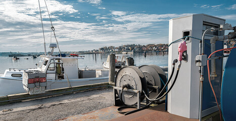 Dockside Fuel Station:  An industrial fuel pump is positioned to serve either boats or land vehicles at a waterfront site in New England.
