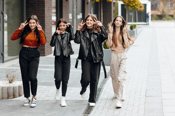 Group of smiling and happy teenage friends wearing casual clothes spending time together, posing...