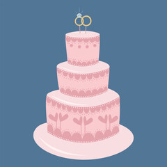 Beautiful pink wedding cake with two rings on top.