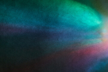 Soft Bright multicolored glare on dark rough textured cardboard. Soft rainbow light. Abstract...