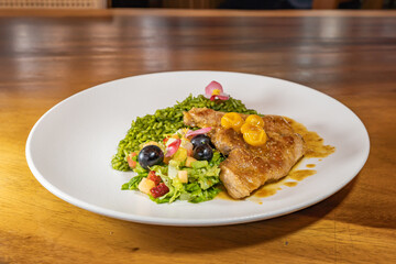 chicken breast with cape gooseberry sauce, green rice and fruit salad