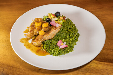 chicken breast with cape gooseberry sauce, green rice and fruit salad